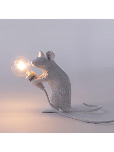 stehende weiße Maus mit Glühbirne in der Hand